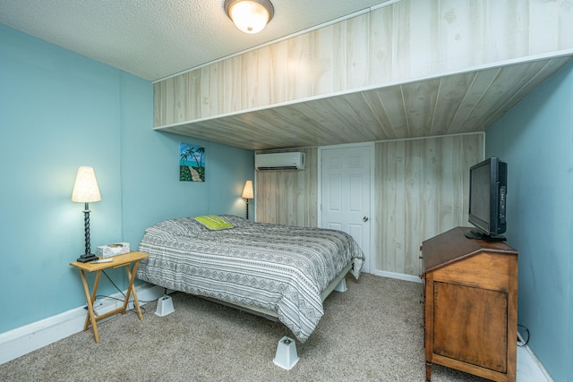 carpeted bedroom with an AC wall unit