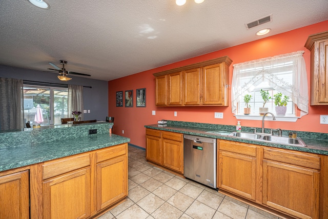 kitchen featuring a textured ceiling, dishwasher, ceiling fan, and sink