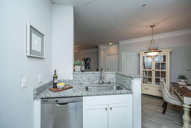 kitchen featuring white cabinets, light stone counters, hardwood / wood-style flooring, dishwasher, and sink