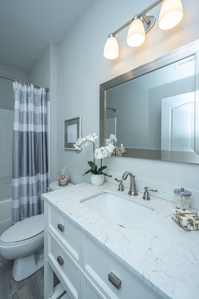 full bathroom featuring vanity, toilet, and shower / bath combo with shower curtain