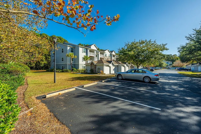 view of car parking featuring a lawn