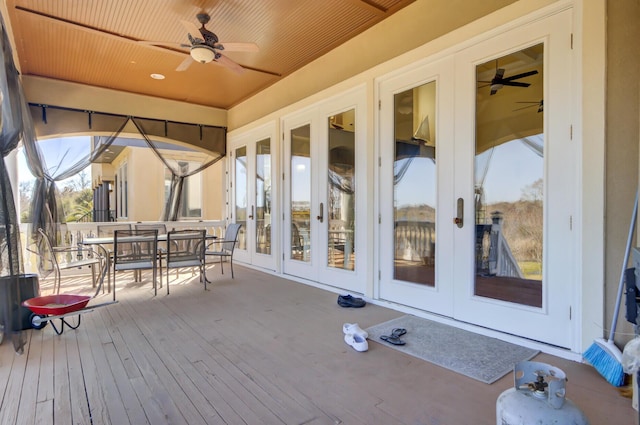 deck with a ceiling fan, outdoor dining area, and french doors