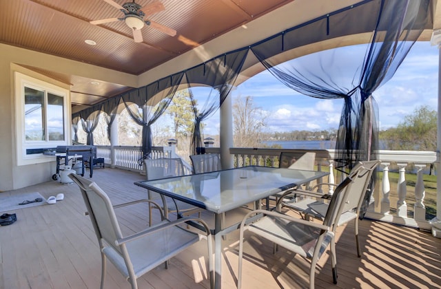 exterior space with outdoor dining space, a wooden deck, and ceiling fan