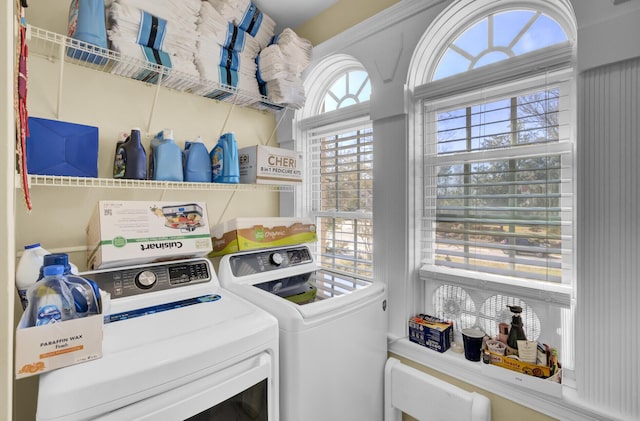 clothes washing area featuring separate washer and dryer and laundry area