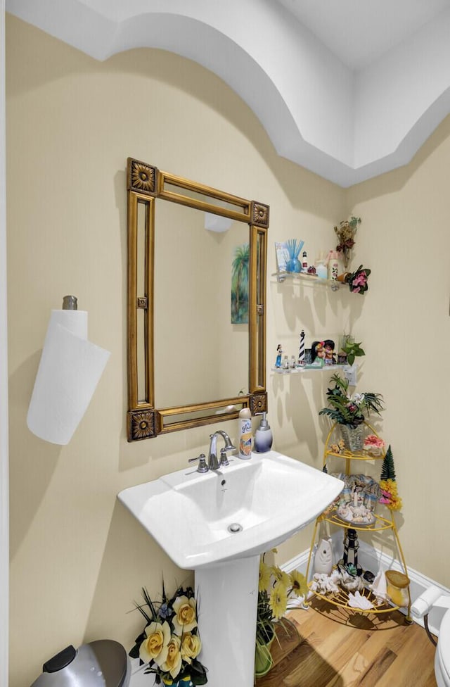 bathroom with wood finished floors and baseboards
