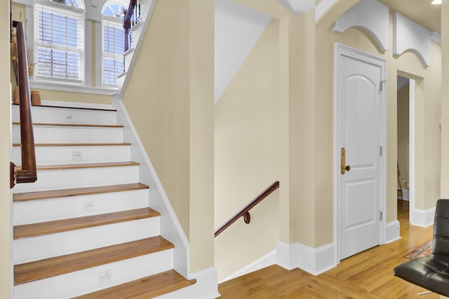 stairway featuring baseboards and wood finished floors