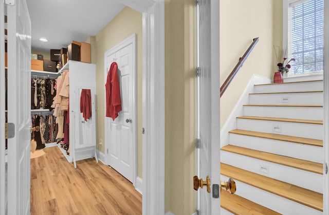 stairway featuring recessed lighting and wood finished floors