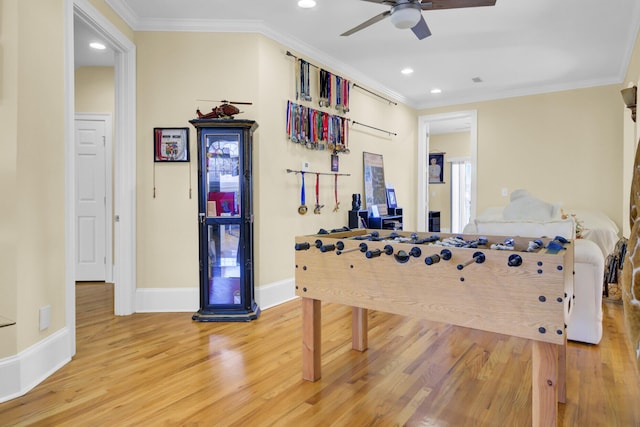 playroom featuring baseboards, crown molding, ceiling fan, and wood finished floors