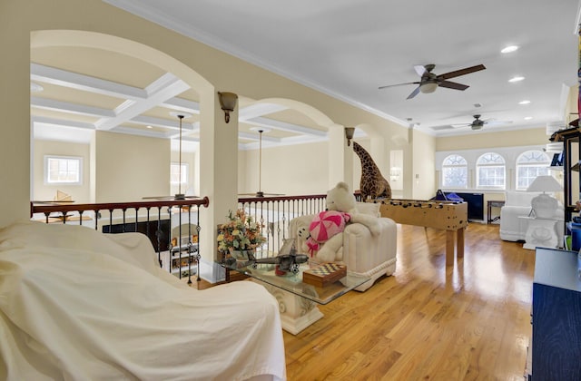 living area featuring a ceiling fan, coffered ceiling, wood finished floors, recessed lighting, and crown molding
