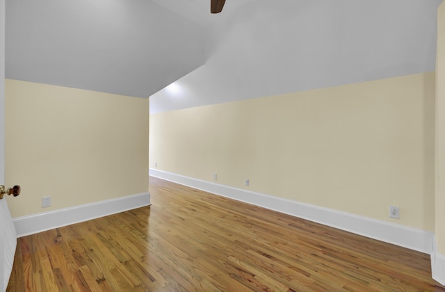 bonus room featuring a ceiling fan, vaulted ceiling, wood finished floors, and baseboards
