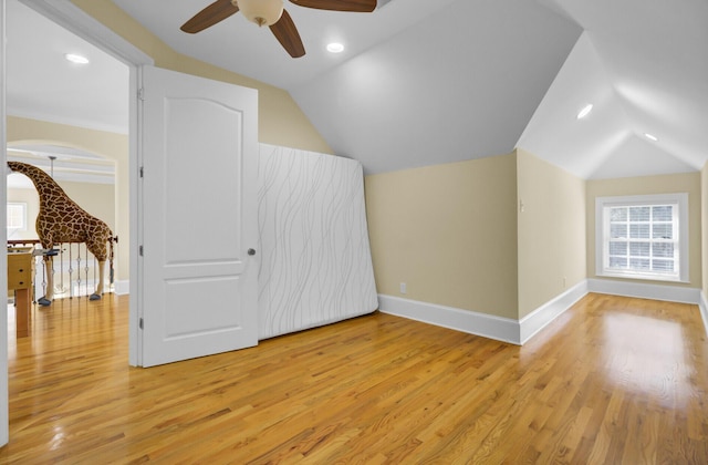 bonus room featuring lofted ceiling, a ceiling fan, and light wood-type flooring