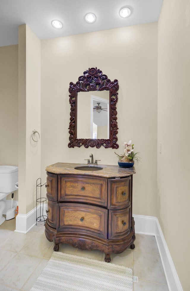 interior space with recessed lighting, baseboards, toilet, and vanity