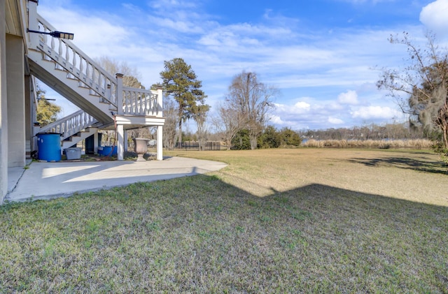 view of yard featuring stairs, a patio, and fence