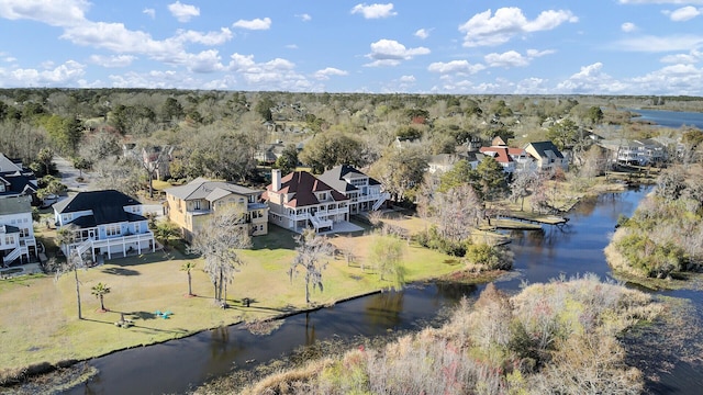 aerial view with a forest view, a water view, and a residential view