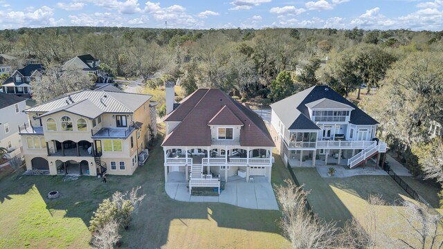 aerial view featuring a wooded view and a residential view