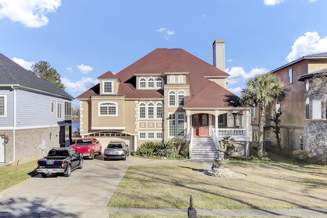 view of front of home with concrete driveway, an attached garage, and a chimney