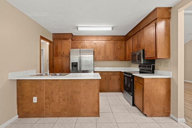8116 Long Shadow Ln, North Charleston, SC 29406 - kitchen featuring stainless steel appliances, a peninsula, brown cabinetry, and light countertops