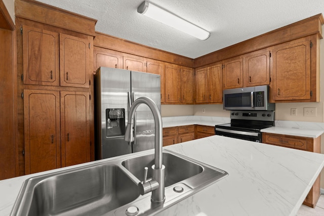 8116 Long Shadow Ln, North Charleston, SC 29406 - kitchen featuring appliances with stainless steel finishes, brown cabinetry, a textured ceiling, and light countertops