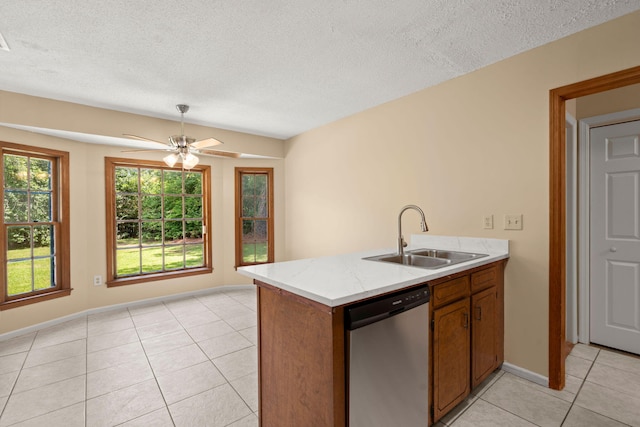 8116 Long Shadow Ln, North Charleston, SC 29406 - kitchen with stainless steel dishwasher, light tile patterned floors, brown cabinetry, ceiling fan, and a textured ceiling