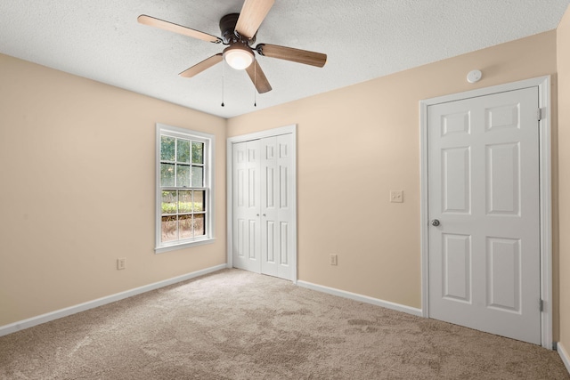 8116 Long Shadow Ln, North Charleston, SC 29406 - unfurnished bedroom featuring carpet flooring, a closet, a textured ceiling, and a ceiling fan