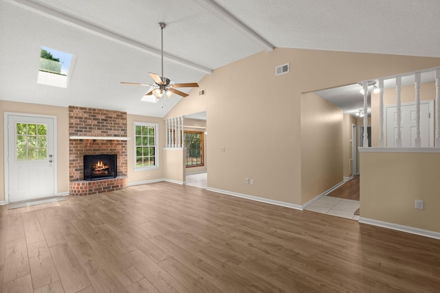 8116 Long Shadow Ln, North Charleston, SC 29406 - unfurnished living room featuring beamed ceiling, light wood finished floors, a ceiling fan, a skylight, and high vaulted ceiling