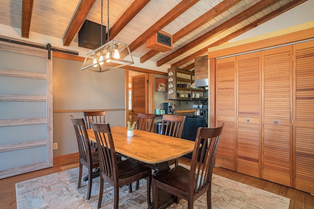 520 E Huron Ave, Folly Beach, SC 29439 - dining room featuring wood ceiling, a barn door, and wood finished floors