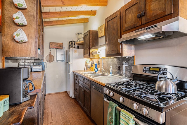 520 E Huron Ave, Folly Beach, SC 29439 - kitchen with appliances with stainless steel finishes, under cabinet range hood, hardwood / wood-style floors, decorative backsplash, and open shelves