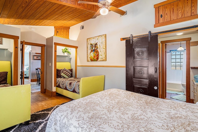 520 E Huron Ave, Folly Beach, SC 29439 - bedroom with wood ceiling, a barn door, wood finished floors, and vaulted ceiling