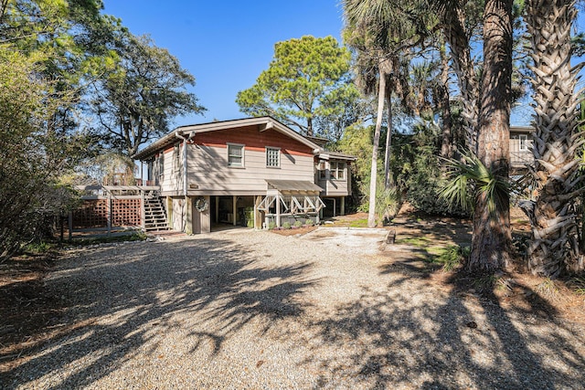 520 E Huron Ave, Folly Beach, SC 29439 - view of side of home featuring a carport, stairs, and driveway