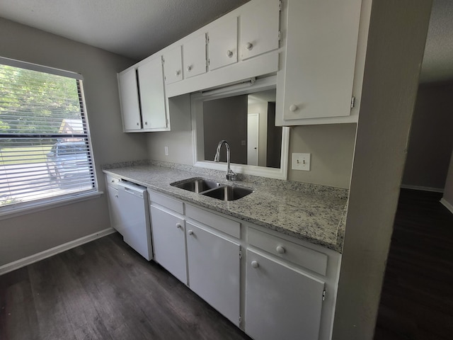 kitchen with light stone countertops, dishwasher, sink, dark hardwood / wood-style floors, and white cabinets