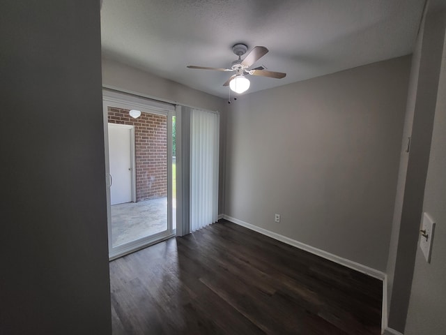 spare room featuring a textured ceiling, ceiling fan, and dark wood-type flooring