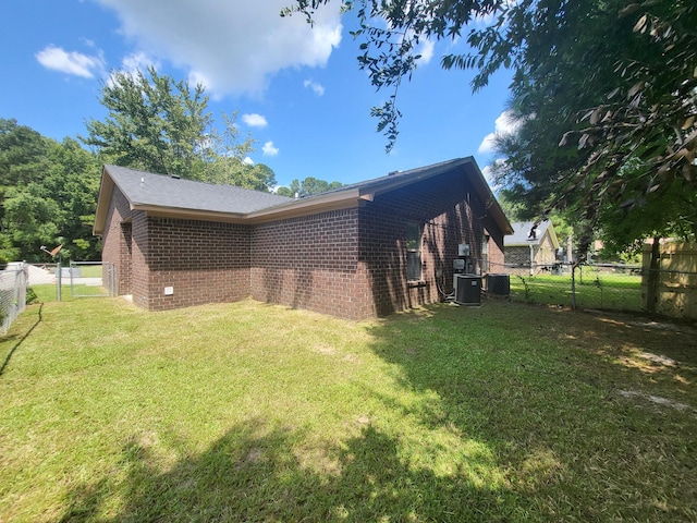 view of property exterior featuring a yard and central AC