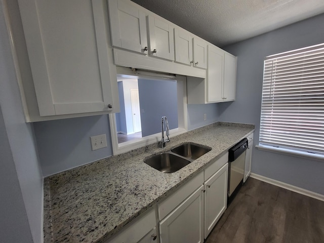 kitchen featuring dishwasher, sink, dark hardwood / wood-style flooring, light stone counters, and white cabinetry