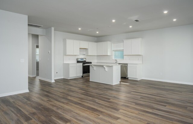 kitchen featuring dark wood-type flooring, appliances with stainless steel finishes, and a kitchen island