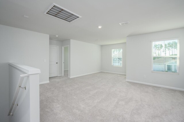 unfurnished room featuring light colored carpet