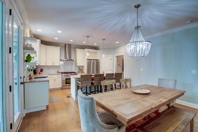 1976 Liberia Rd, Wadmalaw Island, SC 29487 - dining area with light wood-style flooring, a chandelier, recessed lighting, and ornamental molding