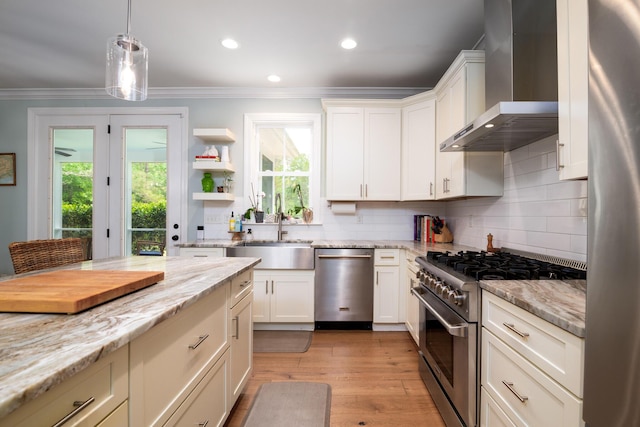 1976 Liberia Rd, Wadmalaw Island, SC 29487 - kitchen featuring stainless steel appliances, wall chimney range hood, a sink, ornamental molding, and tasteful backsplash