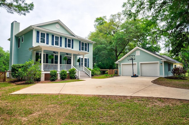 1976 Liberia Rd, Wadmalaw Island, SC 29487 - view of front facade featuring covered porch, a chimney, ceiling fan, a front yard, and a garage