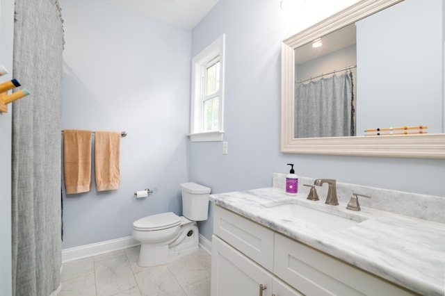 1976 Liberia Rd, Wadmalaw Island, SC 29487 - bathroom with baseboards, marble look tile flooring, toilet, and vanity
