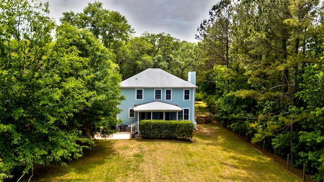 1976 Liberia Rd, Wadmalaw Island, SC 29487 - rear view of property with a chimney and a wooded view