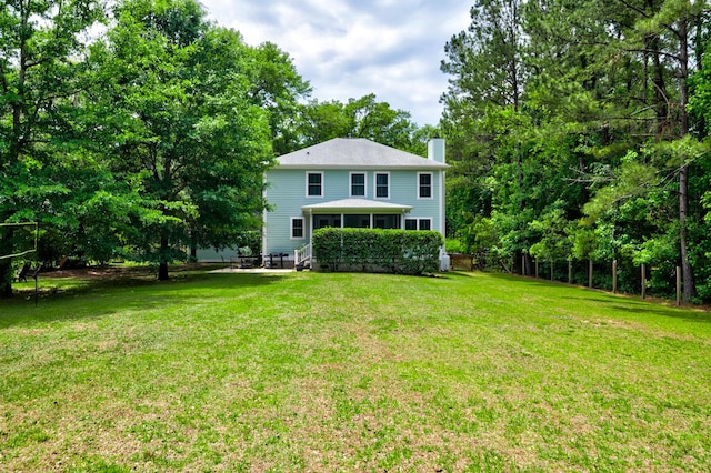 1976 Liberia Rd, Wadmalaw Island, SC 29487 - back of property featuring a chimney and a lawn
