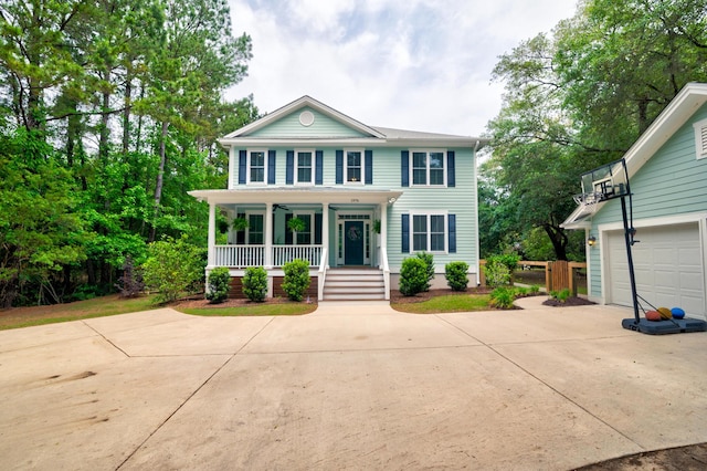 1976 Liberia Rd, Wadmalaw Island, SC 29487 - view of front facade featuring a porch, concrete driveway, and a garage