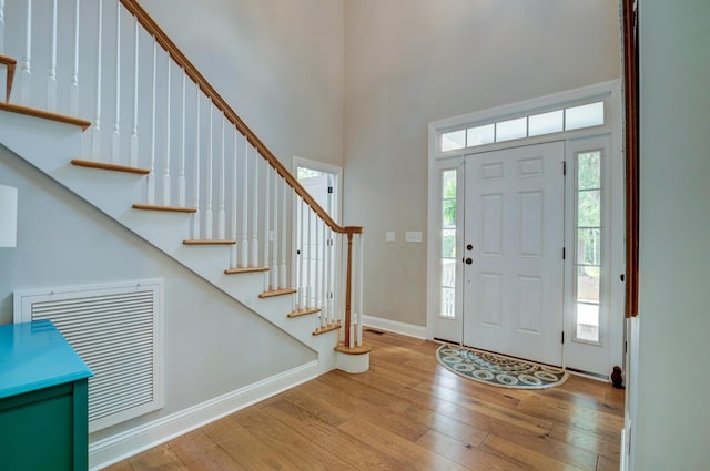 1976 Liberia Rd, Wadmalaw Island, SC 29487 - foyer entrance with hardwood / wood-style floors, baseboards, a towering ceiling, and stairway