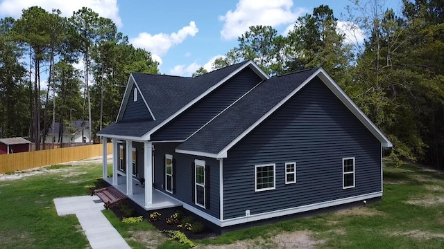 view of home's exterior featuring a lawn and a porch