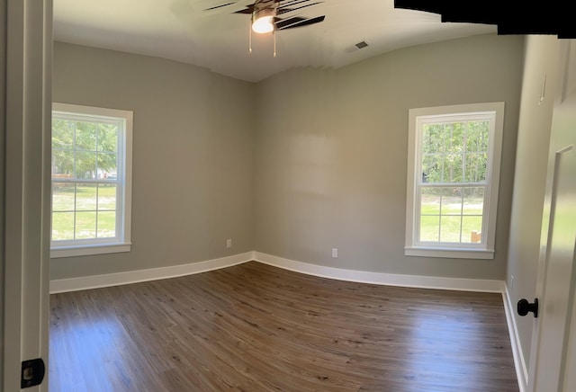 spare room with dark hardwood / wood-style floors and ceiling fan