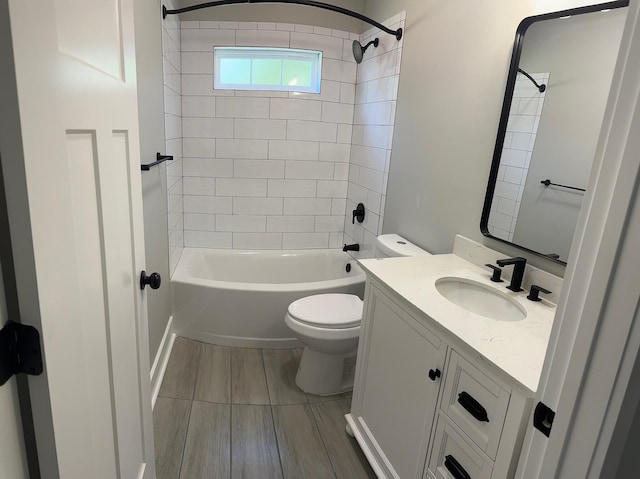 full bathroom with vanity, tiled shower / bath combo, and toilet