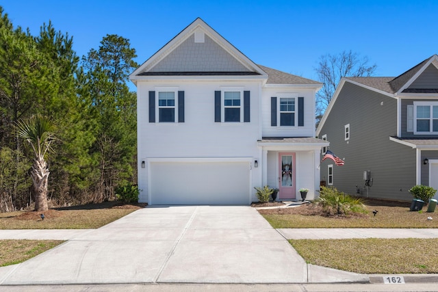 view of front of property with concrete driveway, a garage, and a shingled roof