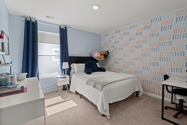 bedroom featuring light carpet, visible vents, and baseboards