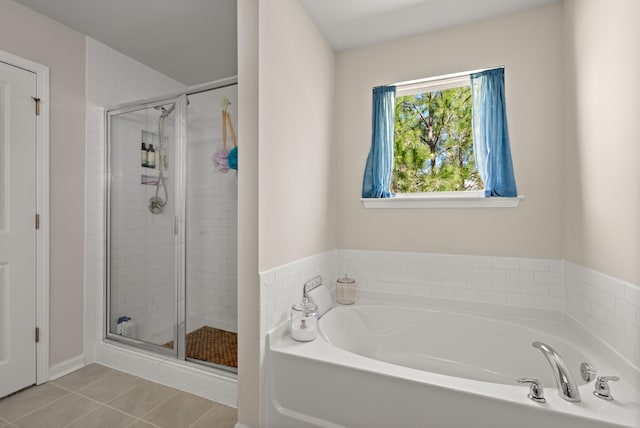 full bath with tile patterned floors, a garden tub, and a stall shower