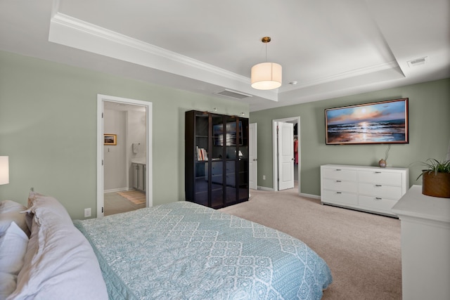 carpeted bedroom featuring a tray ceiling, baseboards, and visible vents